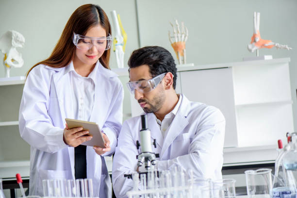 istock Attractive happiness scientist lab technician assistant analyzing sample in test tube at laboratory. Medical, pharmaceutical and scientific research and development concept. 1273335287