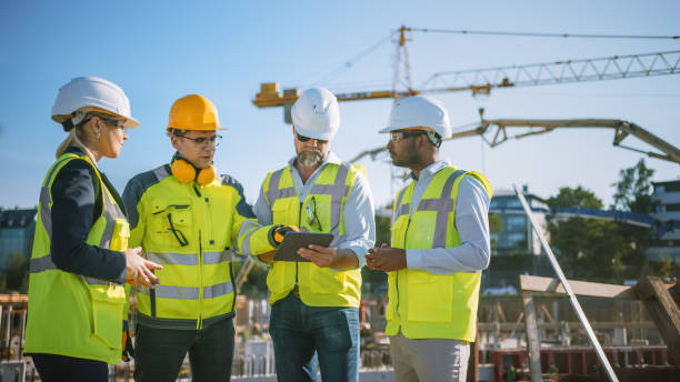 istock Diverse Team of Specialists Use Tablet Computer on Construction Site. Real Estate Building Project with Civil Engineer, Architect, Business Investor and General Worker Discussing Plan Details. 1273337021