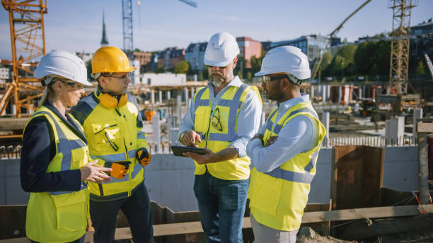 istock Diverse Team of Specialists Use Tablet Computer on Construction Site. Real Estate Building Project with Civil Engineer, Architect, Business Investor and General Worker Discussing Plan Details. 1273337043