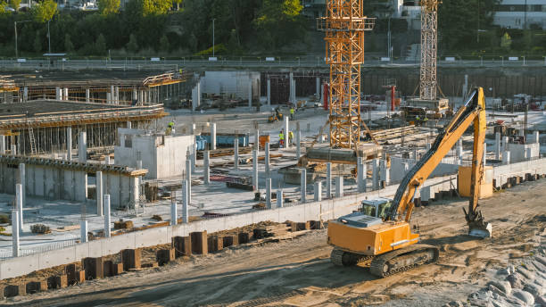 istock Aerial Shot of a New Constructions Development Site with High Tower Cranes Building Real Estate. Heavy Machinery and Construction Workers are Employed. Steel Metal and Concrete Building Frame. 1273337661
