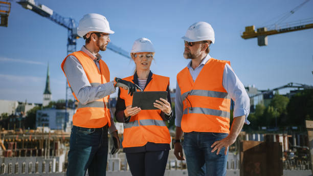 istock Diverse Team of Specialists Use Tablet Computer on Construction Site. Real Estate Building Project with Civil Engineer, Architect, Business Investor Discussing Planning and Development Details. 1273337705