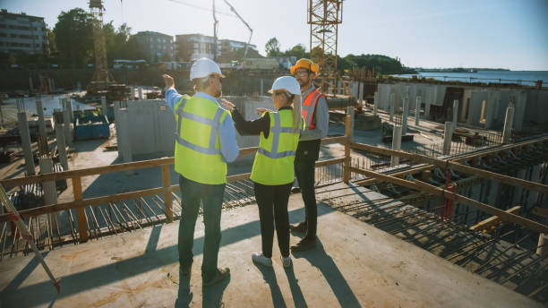 istock Diverse Team of Specialists Are on Construction Site. Real Estate Building Project with Civil Engineer, Architect, Business Finance Investor Discussing Planning and Development Details. 1273337708