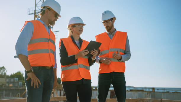 istock Diverse Team of Specialists Use Tablet Computer on Construction Site. Real Estate Building Project with Civil Engineer, Architect, Business Investor Discussing Planning and Development Details. 1273337865