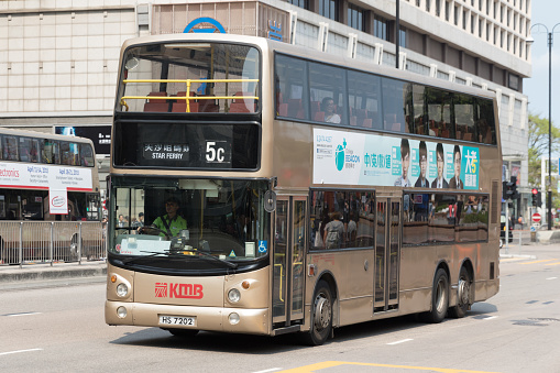 Passengers on the Kowloon Motor Bus Dennis Trident 12m in Tsim Sha Tsui, Kowloon, Hong Kong. It is the first type double-deck low-floor bus in Hong Kong.