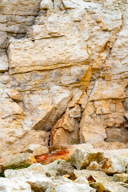 Cliff face at Hunstanton The chalk and sandstone cliffs are constantly being eroded and collapsing on to the beach.  This shows the different coloured rock strata and cracks between them that make them exceptionally unstable. fault geology stock pictures, royalty-free photos & images