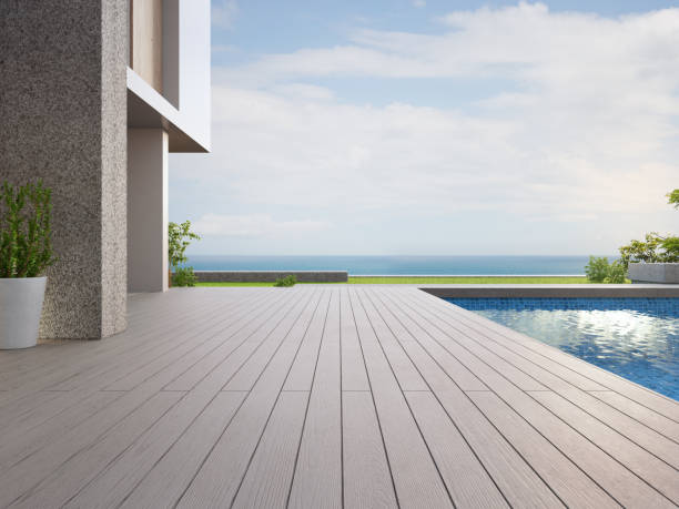 terrasse extérieure vide de plancher près de la piscine et du jardin d’herbe verte dans la maison moderne de plage ou la villa de luxe. - garden patio photos et images de collection