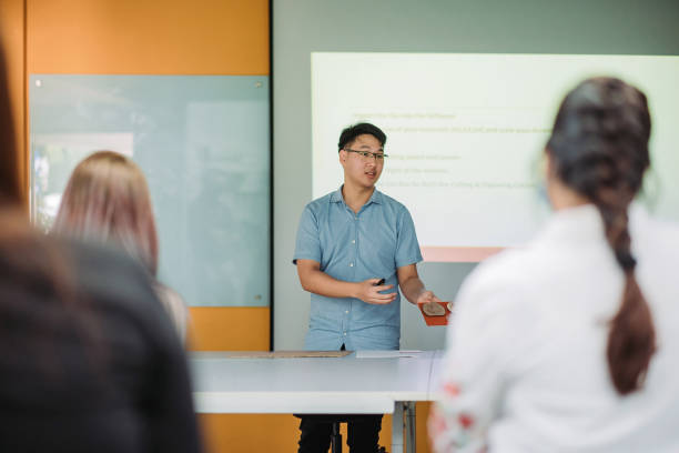 istock Asian chinese male student presenting in college classroom 1273342840