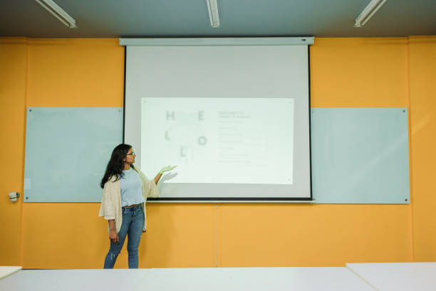 istock Asian indian smiling female student presenting in college classroom 1273343503