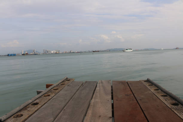 istock Low angle view through a wooden pier to the ocean 1273344163