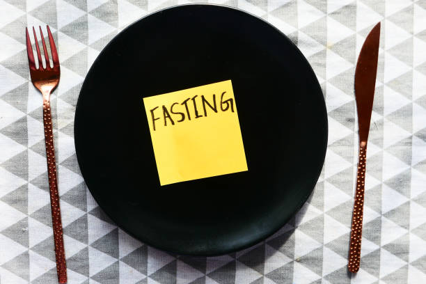 istock top view of fating word on sticky note on empty plate . 1273344263