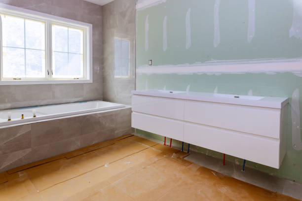 istock Home construction bathtub tiled walls after installing remodeling master bathroom patching drywall 1273344798