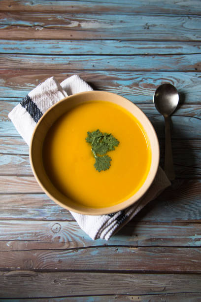 istock Fresh pumpkin soup and parsley in a bowl 1273345039
