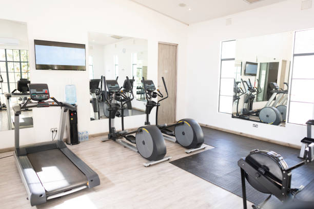 istock Exercise machines in small gym with TV screen on the wall 1273345264
