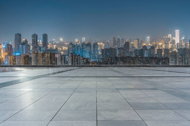 istock empty concrete ground in downtown with illuminated modern cityscape and buildings at night. 1273348959