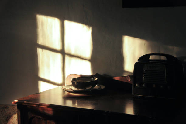 istock Abstract still life on a silver bowl and an old radio with a reflecting sun effect 1273349074