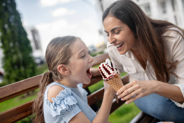 istock Mom and daughter eating ice-cream and having fun 1273349310