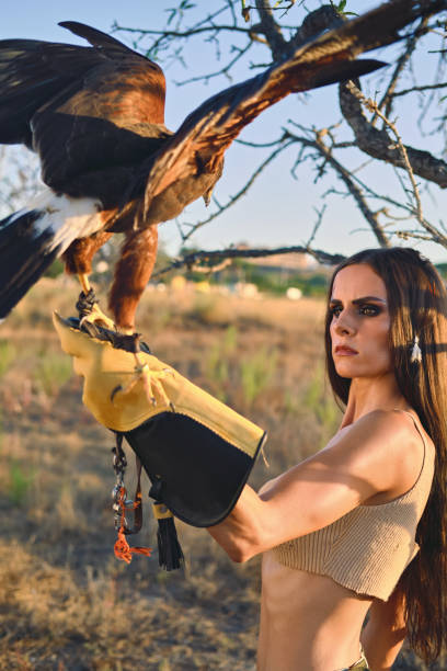 istock Beautiful woman posing on nature with eagle 1273349861