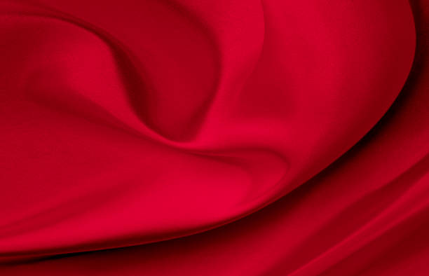 istock Black red satin dark fabric texture luxurious shiny that is abstract silk cloth background with patterns soft waves blur beautiful. 1273350595