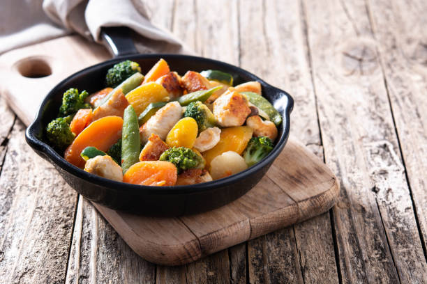 istock Stir fry chicken with vegetables on iron pan 1273350761