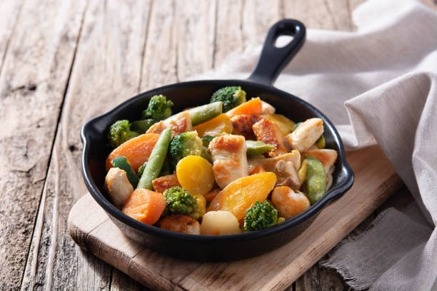istock Stir fry chicken with vegetables on iron pan 1273350767