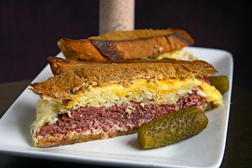 pastrami sandwich with sauerkraut, cheese, sauce and toasted bread