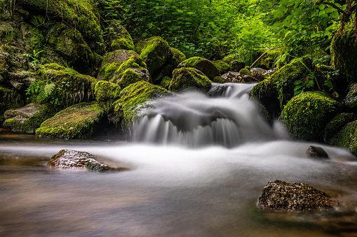 long exposure shot of a tiny waterfall in black forest, germany