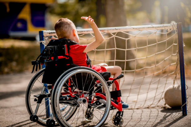 istock Disabled boy playing with sports ball 1273353637
