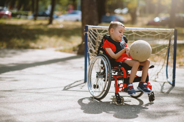 istock Disabled boy with sports ball 1273353833