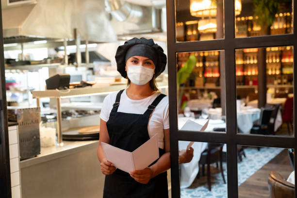 istock Chef working in a commercial kitchen wearing a facemask 1273354326