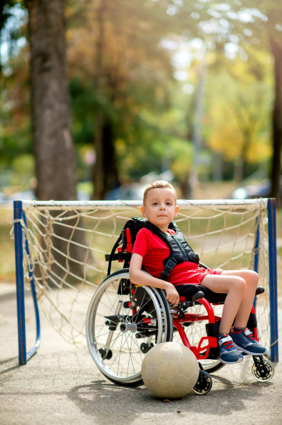 istock Disabled boy with sports ball 1273354430