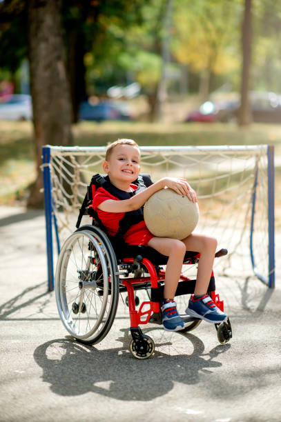 istock Disabled boy with sports ball 1273354463