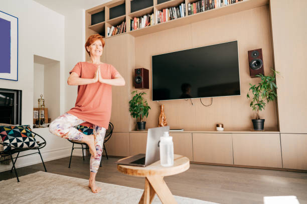 istock Senior woman exercising  at home 1273355802