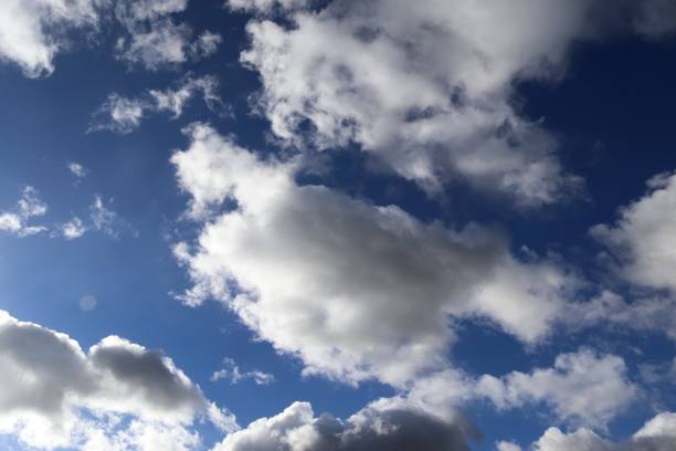 istock Beautiful fluffy white cloud formations in a deep blue summer sky 1273356587