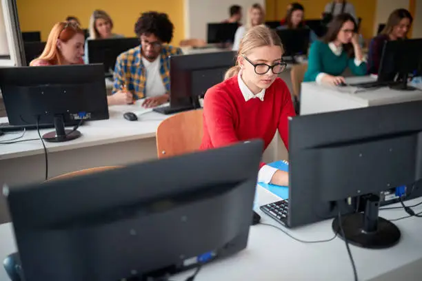 Students focused on work at an informatics lecture in the university computer classroom