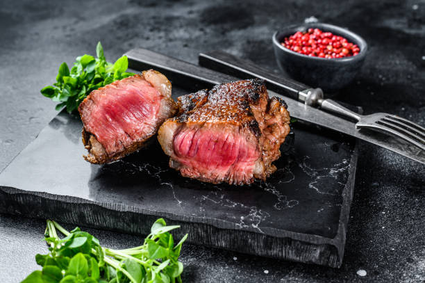 istock Grilled rump marble Beef steak. Black background. Top view 1273358561