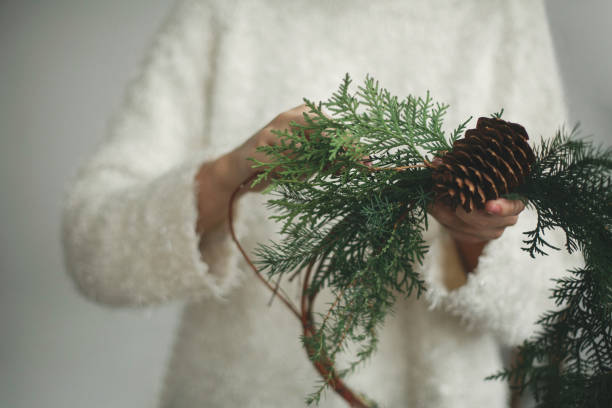 istock Rustic christmas wreath in female hands. 1273361822
