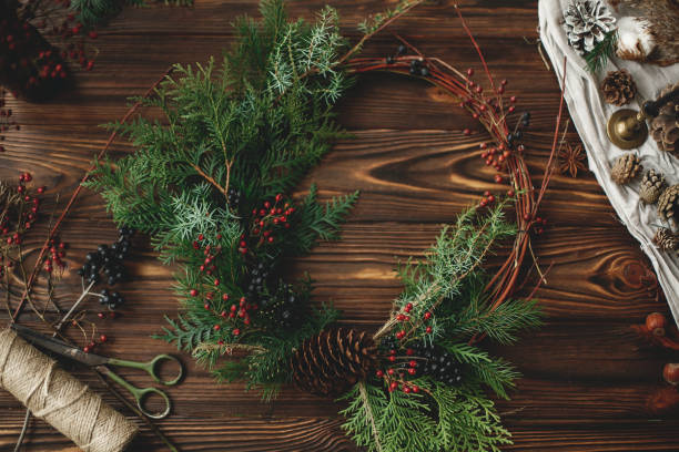 istock Rustic christmas wreath on wooden table flat lay. 1273362386