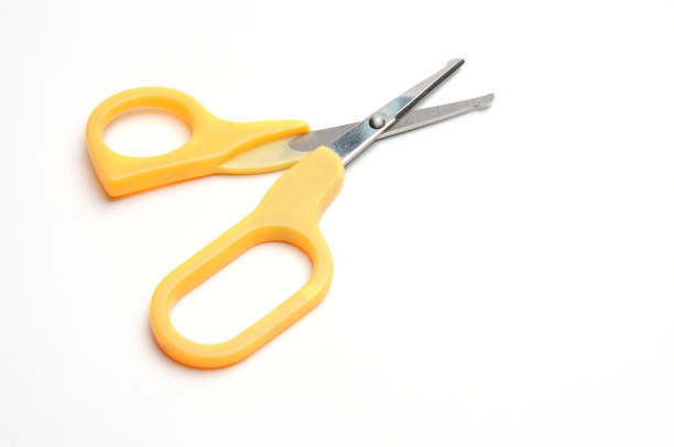 Yellow baby scissors on an isolated white background/Blue baby scissors on an isolated white background