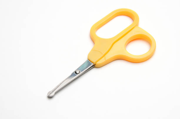 istock Yellow baby scissors on a white background 1273362449
