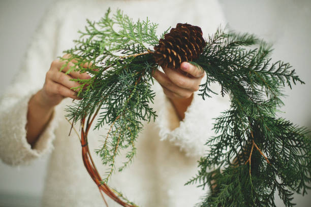 istock Rustic christmas wreath in female hands. 1273362573