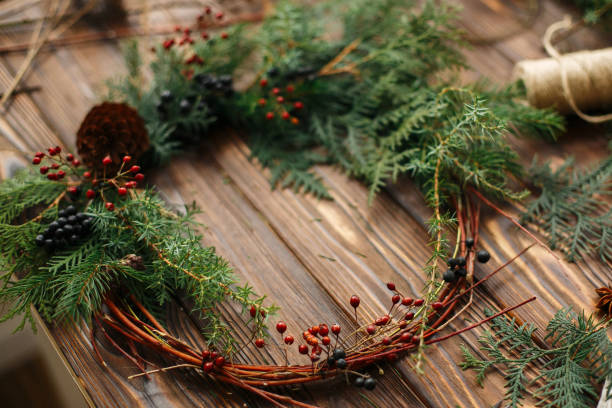 istock Rustic christmas wreath on wooden table, holiday advent. 1273362625