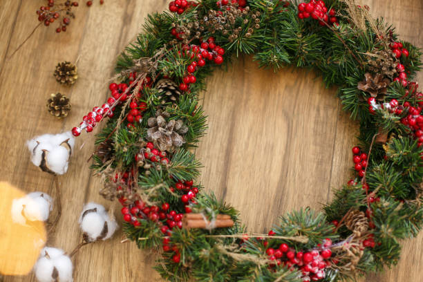 istock Christmas wreath on wooden rustic background in house. 1273362662