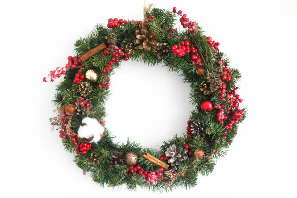 istock Christmas wreath hanging on white wall in house 1273363653