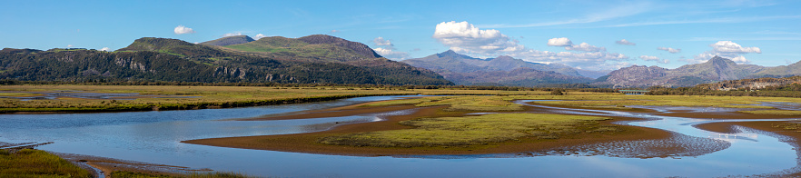 The stunning Panoramic view of Snowdonia National Park from Traeth Glaslyn Nature Reserve in North Wales, UK.