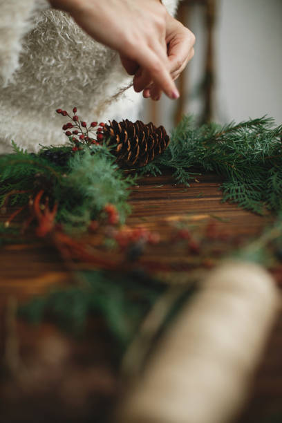 istock Making stylish rustic christmas wreath with natural decorations. 1273364240