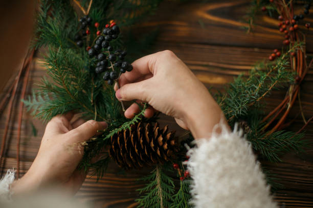 istock Making stylish rustic christmas wreath with natural decorations. 1273364907