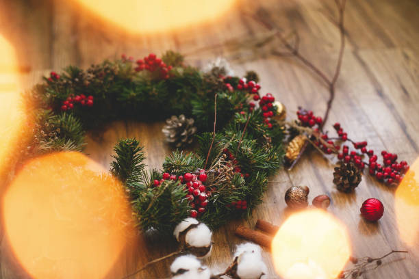 istock Christmas wreath on wooden rustic background in lights 1273364955
