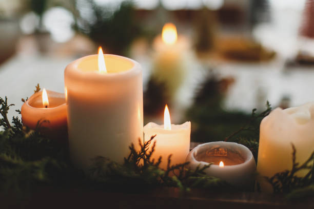 istock Burning candles on rustic background with christmas wreath, cozy winter advent 1273366032