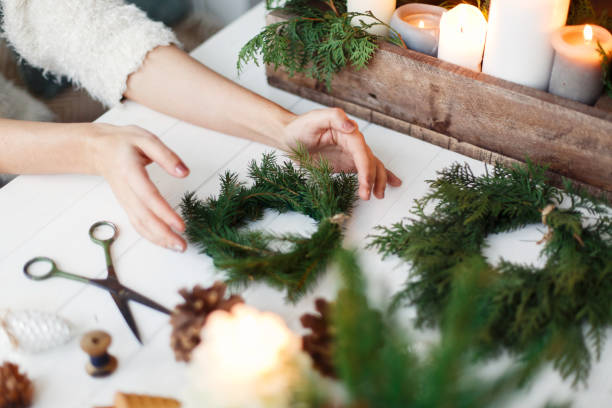 istock Florist hands making simple stylish christmas wreath with fir branches 1273366149