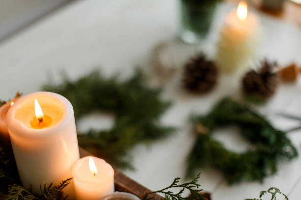 istock Burning candles on rustic background with christmas wreath, cozy winter advent 1273366160